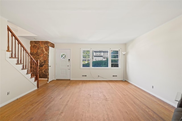31 Westwood Ave, New Rochelle, NY 10801 - unfurnished living room featuring stairway, light wood-style flooring, and baseboards