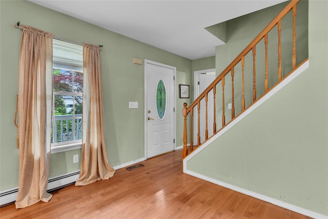 534 Puritan Dr, Shirley, NY 11967 - foyer with wood finished floors, stairs, baseboards, and baseboard heating