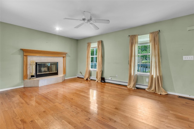 534 Puritan Dr, Shirley, NY 11967 - unfurnished living room featuring wood finished floors, a tile fireplace, ceiling fan, a baseboard radiator, and baseboards