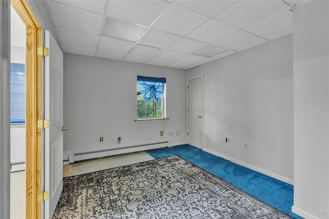 534 Puritan Dr, Shirley, NY 11967 - carpeted spare room featuring a baseboard radiator, a drop ceiling, and baseboards