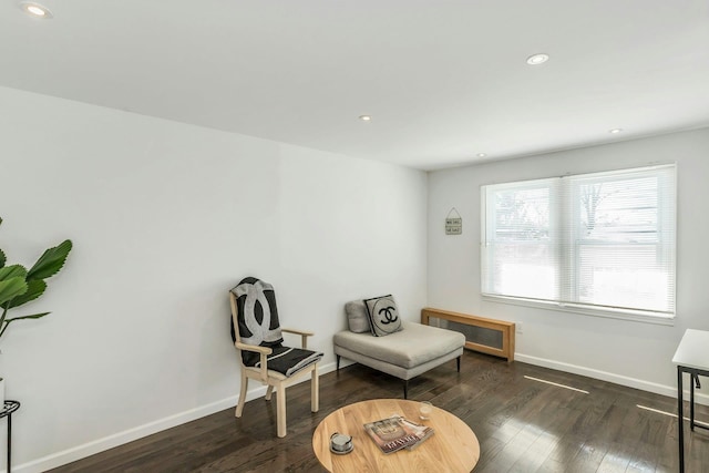 sitting room with baseboards, dark wood-type flooring, and recessed lighting