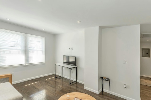 interior space with electric panel, wood finished floors, baseboards, and recessed lighting