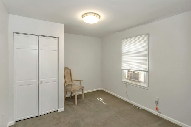 carpeted bedroom featuring baseboards, cooling unit, and a closet
