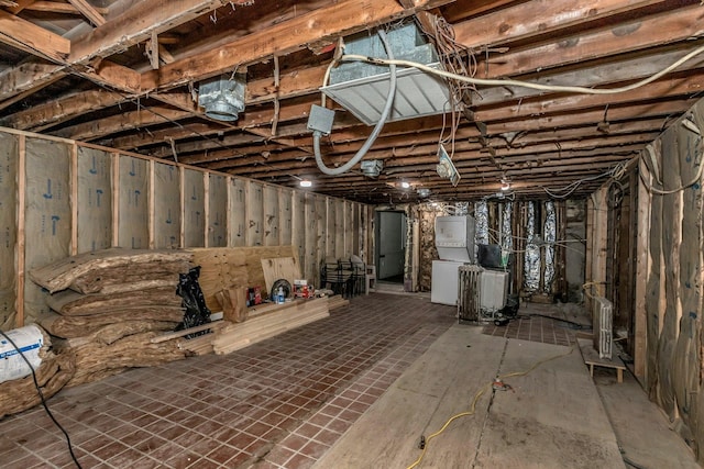 unfinished below grade area with washer / dryer