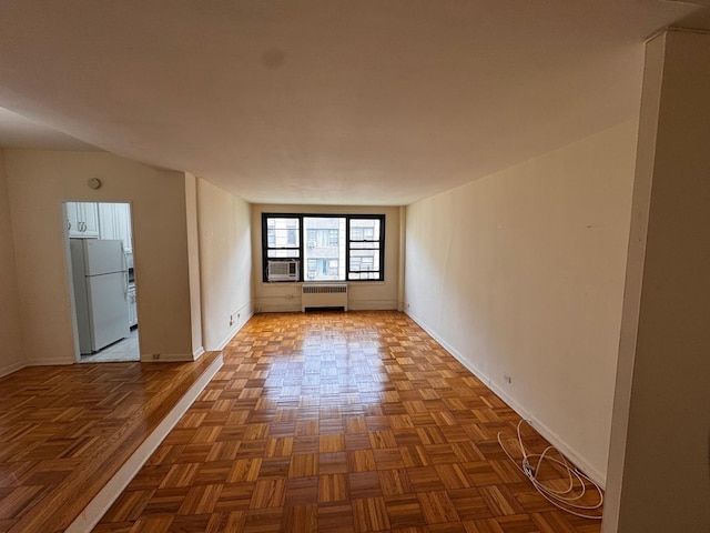 9825 64th Rd Unit 5F, Rego Park, NY 11374 - empty room with radiator, baseboards, and cooling unit