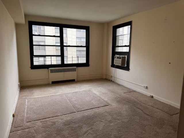 9825 64th Rd Unit 5F, Rego Park, NY 11374 - unfurnished room featuring radiator, carpet floors, cooling unit, and baseboards