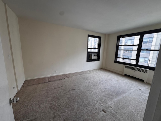 9825 64th Rd Unit 5F, Rego Park, NY 11374 - carpeted spare room featuring radiator and baseboards