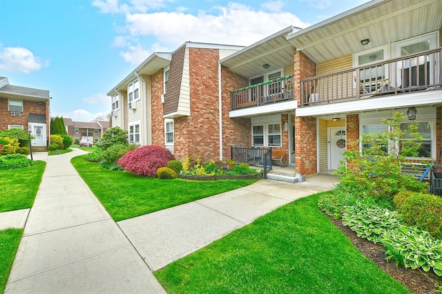 198 Millard Ave Unit 198, West Babylon, NY 11704 - view of front of property featuring a balcony, brick siding, and covered porch