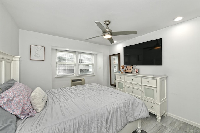 198 Millard Ave Unit 198, West Babylon, NY 11704 - bedroom with light wood finished floors, a wall unit AC, baseboards, a ceiling fan, and recessed lighting
