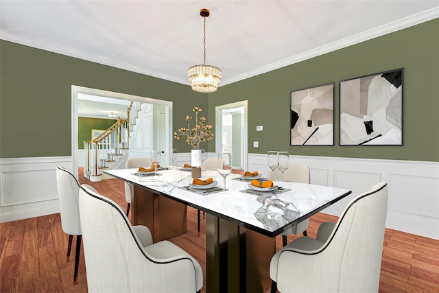 7 Viola Ct, Wappingers Falls, NY 12590 - dining space with a chandelier, stairway, a wainscoted wall, ornamental molding, and dark wood finished floors