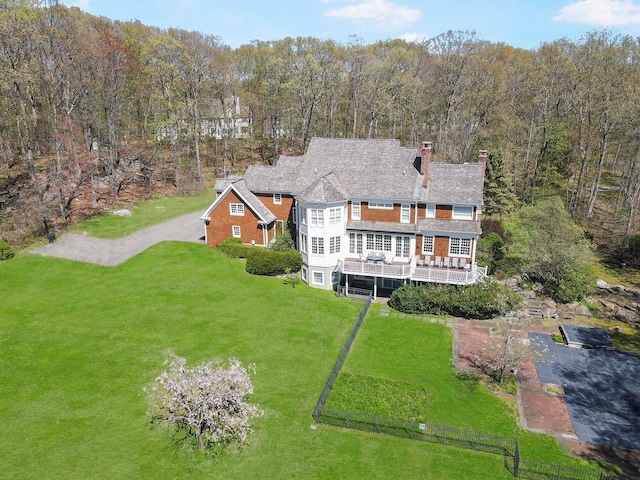 drone / aerial view featuring a wooded view
