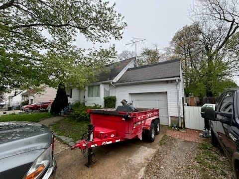 28 Hilliard Ave, Central Islip, NY 11722 - view of home's exterior with a garage