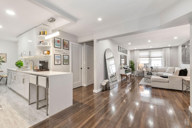 living area featuring wood finished floors, recessed lighting, and baseboards