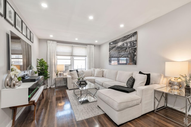 living room with dark wood-type flooring and recessed lighting
