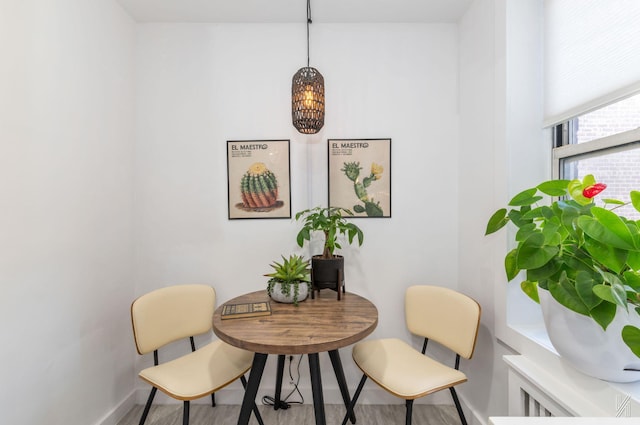 dining area with baseboards and a chandelier