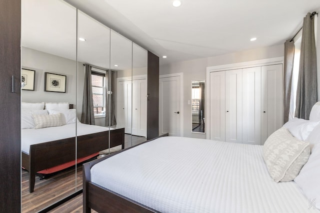 bedroom featuring multiple closets and recessed lighting