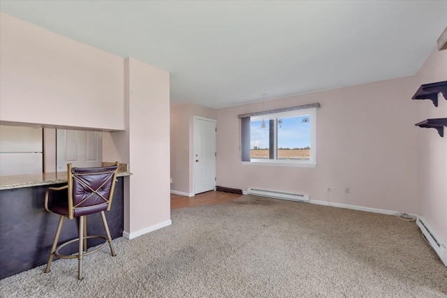 unfurnished room with baseboard heating, carpet floors, baseboards, and a baseboard radiator