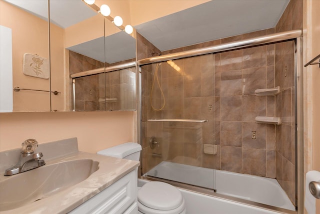 full bath with toilet, enclosed tub / shower combo, and vanity