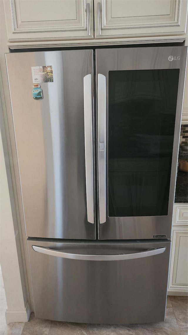 723 Carman Ave Unit 14, Westbury, NY 11590 - kitchen view of smart refrigerator, cream cabinetry, and dark countertops