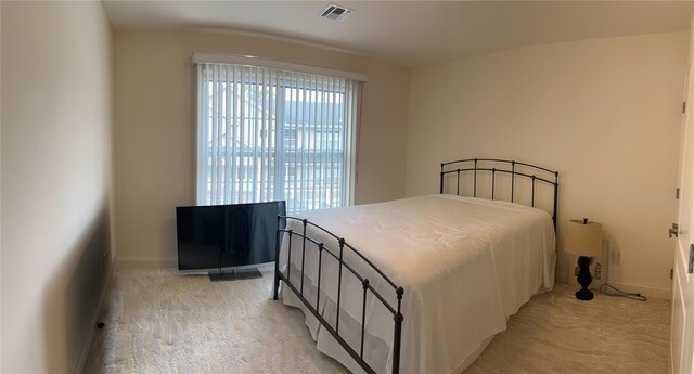 723 Carman Ave Unit 14, Westbury, NY 11590 - bedroom with light carpet and baseboards