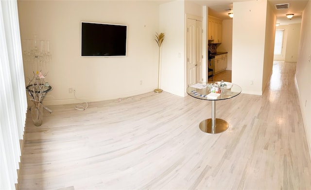 723 Carman Ave Unit 14, Westbury, NY 11590 - unfurnished living room with light wood-type flooring and baseboards