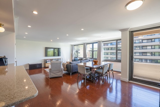 dining space with baseboard heating, dark wood-style floors, and recessed lighting