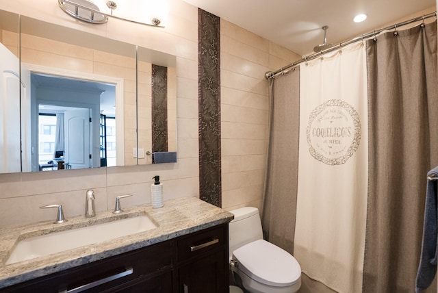 bathroom featuring toilet, vanity, and a shower with shower curtain
