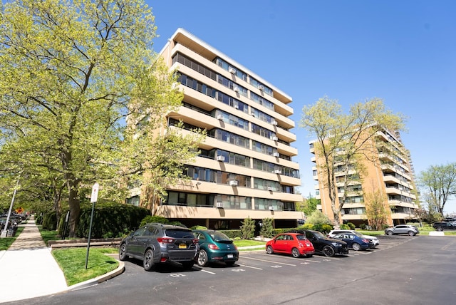 view of apartment building / complex featuring uncovered parking