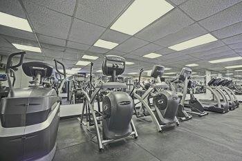 gym with a paneled ceiling