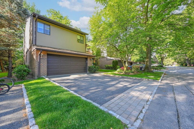 16 Wimbledon Dr, Roslyn, NY 11576 - view of front of house featuring an attached garage, asphalt driveway, and brick siding