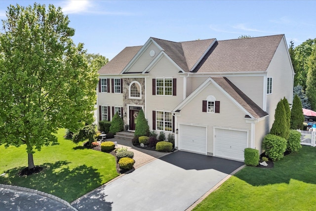 7 Moreland Ct, Mount Sinai, NY 11766 - colonial house featuring asphalt driveway, an attached garage, and roof with shingles