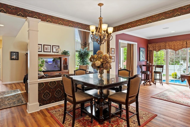 7 Moreland Ct, Mount Sinai, NY 11766 - dining space featuring wood finished floors, a chandelier, crown molding, and baseboards