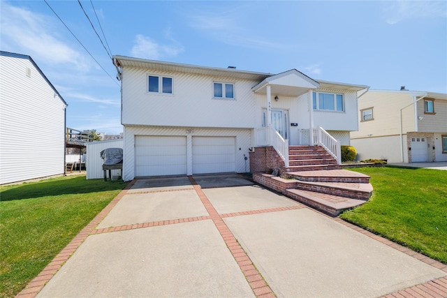 585 Nassau Ave, Freeport, NY 11520 - bi-level home featuring driveway, an attached garage, and a front yard