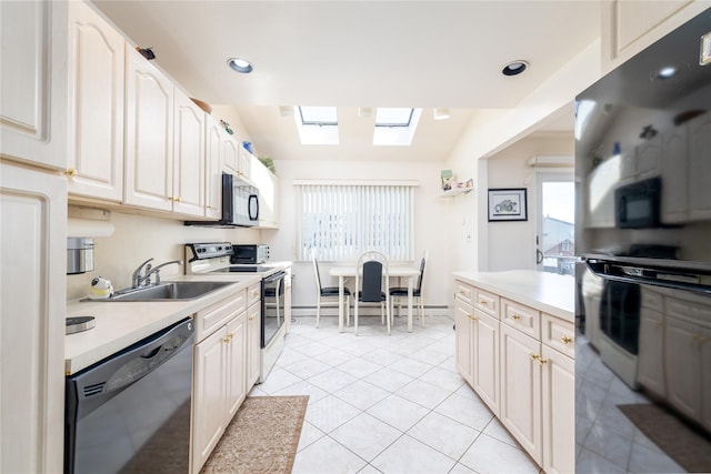 585 Nassau Ave, Freeport, NY 11520 - kitchen with dishwashing machine, electric stove, a sink, a skylight, and light countertops