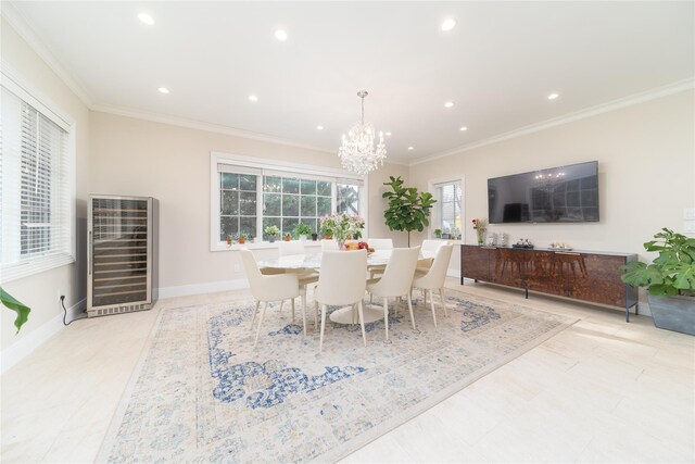 dining area featuring a chandelier, ornamental molding, recessed lighting, beverage cooler, and baseboards