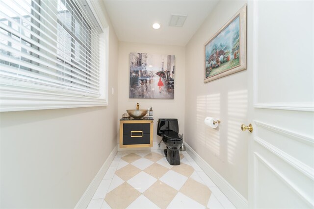 corridor with baseboards, light tile patterned flooring, and recessed lighting