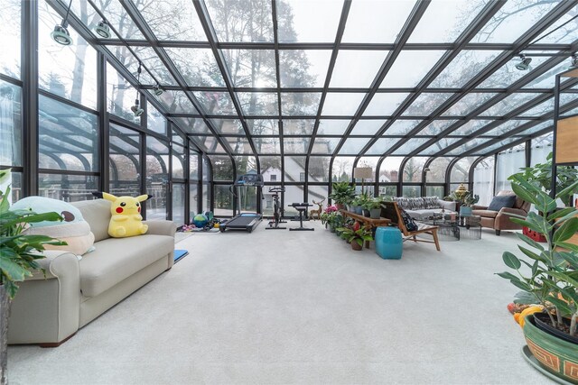 sunroom featuring outdoor lounge area, floor to ceiling windows, and carpet flooring