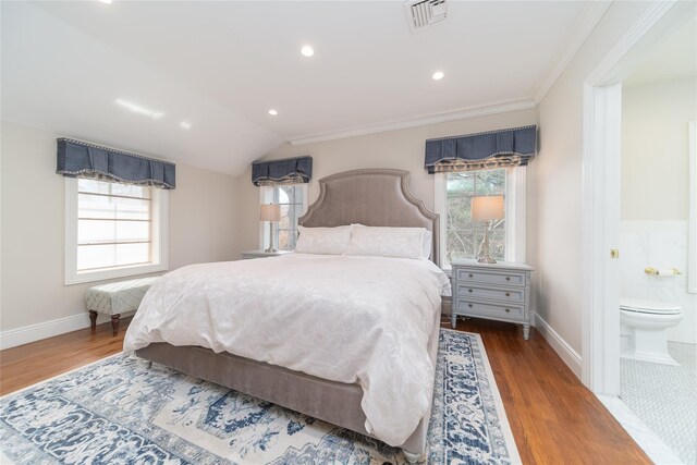 bedroom with wood finished floors, baseboards, recessed lighting, crown molding, and ensuite bath