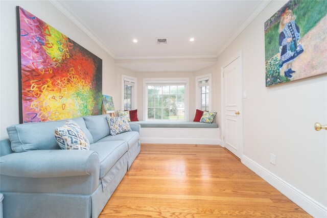 living room featuring light wood-type flooring, baseboards, ornamental molding, and recessed lighting