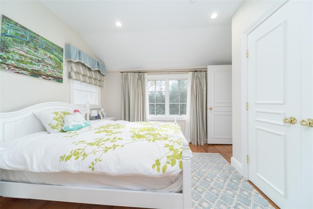 bedroom featuring vaulted ceiling and wood finished floors