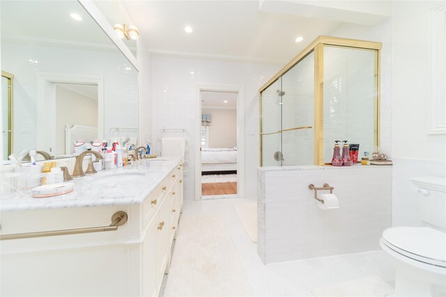 ensuite bathroom with toilet, a stall shower, vanity, tile patterned flooring, and ornamental molding