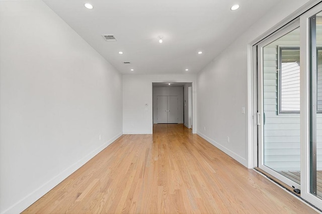 spare room featuring light wood-style flooring, baseboards, and recessed lighting