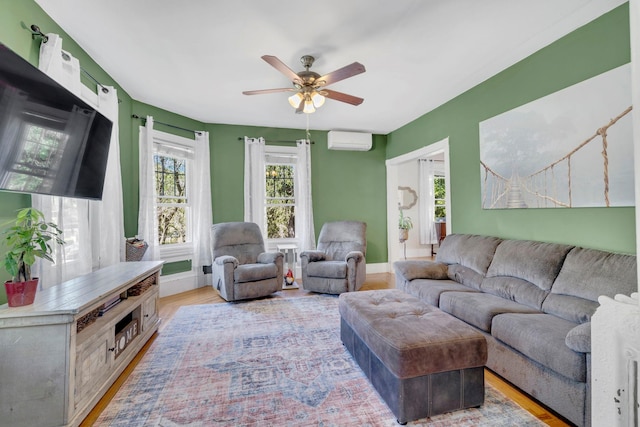 80 Hill St, Walden, NY 12586 - living area featuring baseboards, light wood-style flooring, ceiling fan, and an AC wall unit