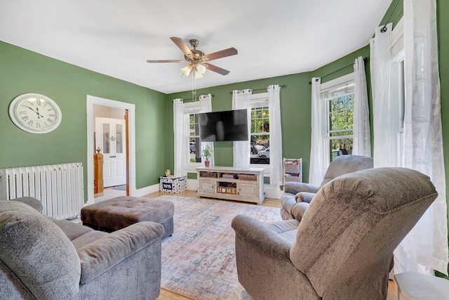 80 Hill St, Walden, NY 12586 - living area with radiator, wood finished floors, baseboards, and ceiling fan