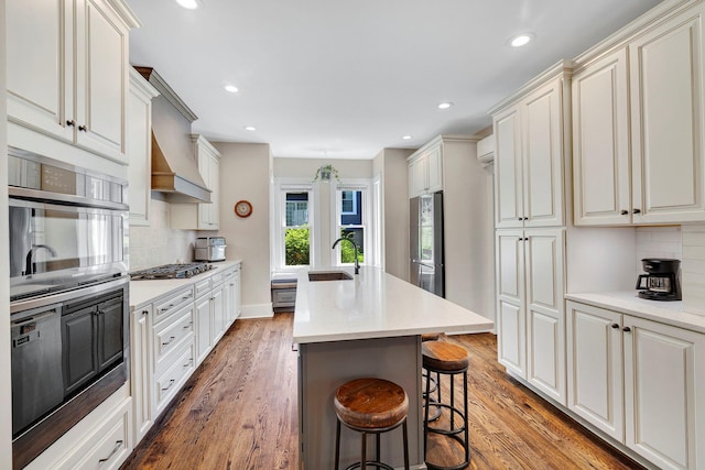 80 Hill St, Walden, NY 12586 - kitchen featuring recessed lighting, a kitchen island with sink, stainless steel appliances, and backsplash