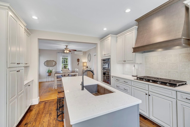 80 Hill St, Walden, NY 12586 - kitchen with a sink, custom exhaust hood, backsplash, a ceiling fan, and appliances with stainless steel finishes