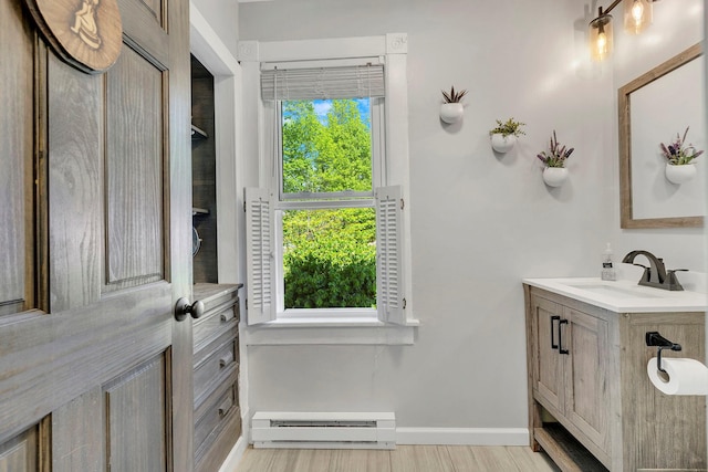 80 Hill St, Walden, NY 12586 - bathroom with vanity, baseboards, baseboard heating, and wood finished floors