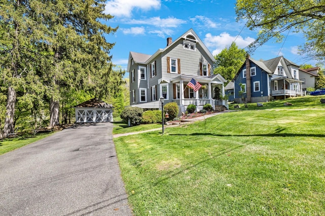 80 Hill St, Walden, NY 12586 - victorian home featuring covered porch, a residential view, a chimney, a front lawn, and an outdoor structure