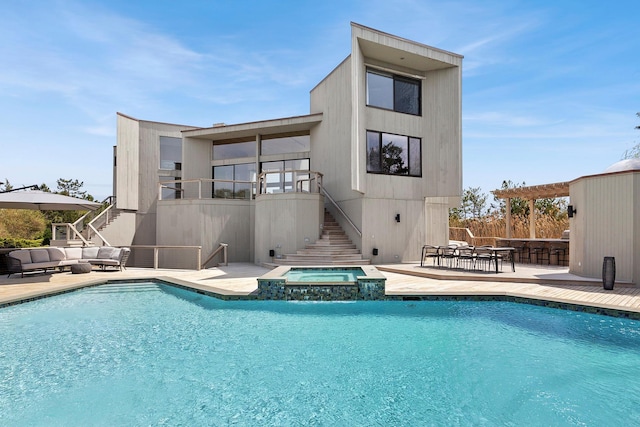 199 Dune Rd, Westhampton Beach, NY 11978 - rear view of property featuring a pool with connected hot tub, outdoor lounge area, a patio, and stairway