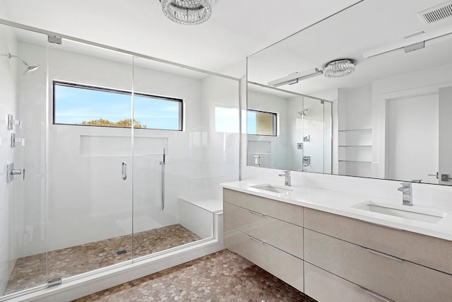 199 Dune Rd, Westhampton Beach, NY 11978 - full bathroom featuring double vanity, visible vents, a stall shower, and a sink